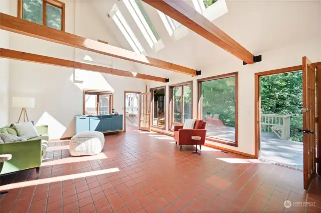Living room has floor to ceiling windows. Door opens to a deck & the yard.