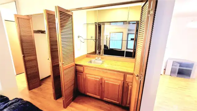 Wet bar with sink is open to family room