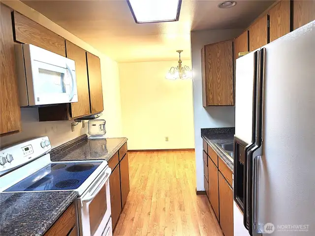 Spacious kitchen with electric range, microwave and a fridge