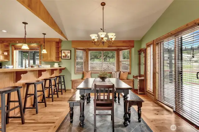 This home home was designed with careful thought showcasing the beautiful outdoors with windows galore. Slate inlay under formal dining table. The sliding glass door leads to the covered deck.