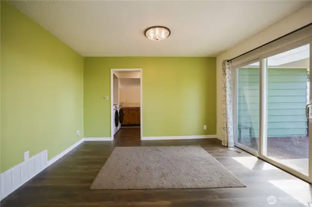 Well-lit dining room with a slider out to the back deck and that stunning view.