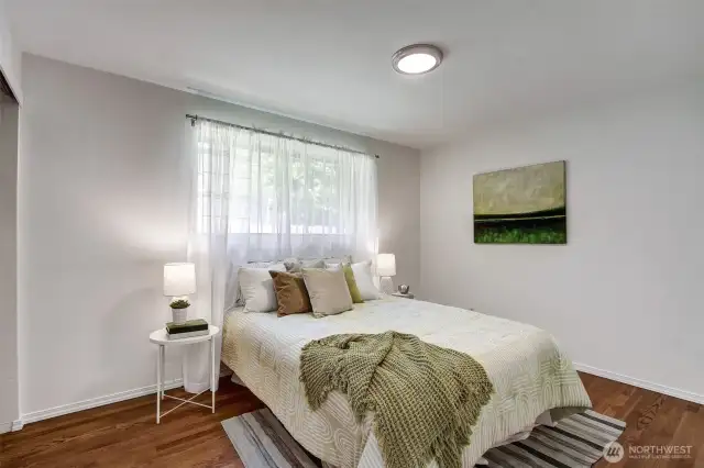 This primary bedroom is a lovely escape from the activities in the rest of the house, tucked in at the far end (from the rec room).
