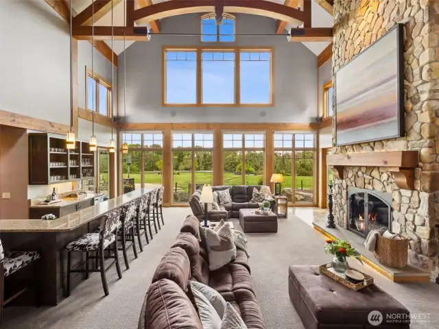 Soaring ceilings and river rock fireplace steal the show in the livingroom