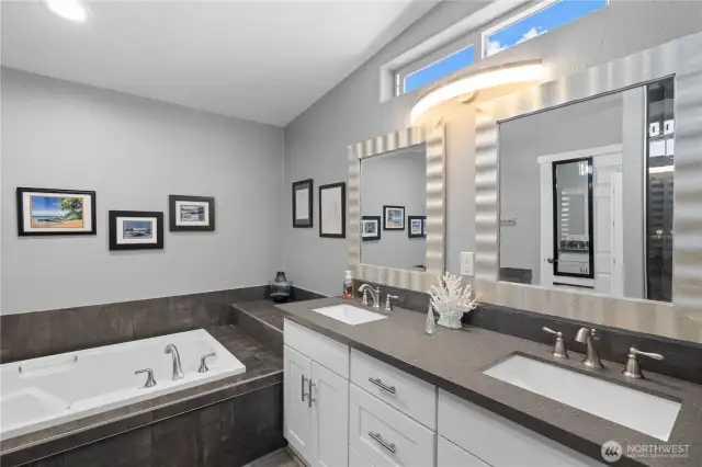 Primary bathroom with dual sinks and soaking tub.