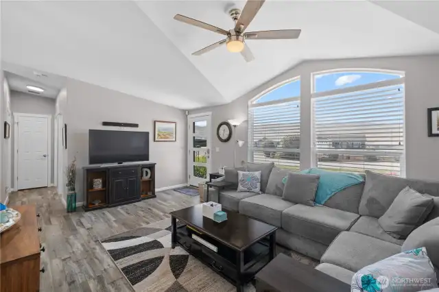 Family room with vaulted ceilings and picture windows.
