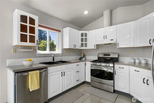 Light and bright kitchen with updated cabinetry, hardware and new stainless appliances.