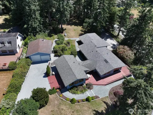 Excellent shot of this corner property. Note there is another driveway that connects to the garage on the south side of the home. Roof is 2 years old. Mature landscaping provides privacy and beauty.
