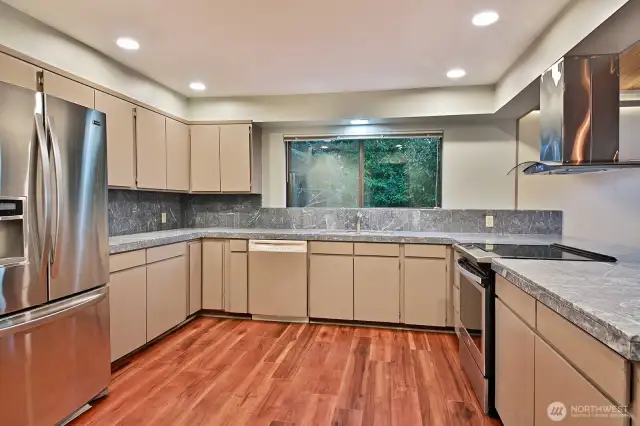 Marble countertops & backsplash, freshly painted, new flooring, newer appliances and the removal of upper cabinets between kitchen and dining/living area brings the view into your kitchen.