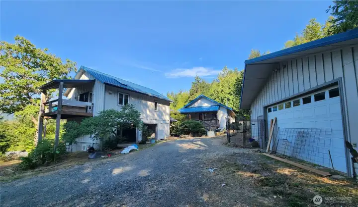 Main Home in middle, ADU & 1st garage on left, second garage on right