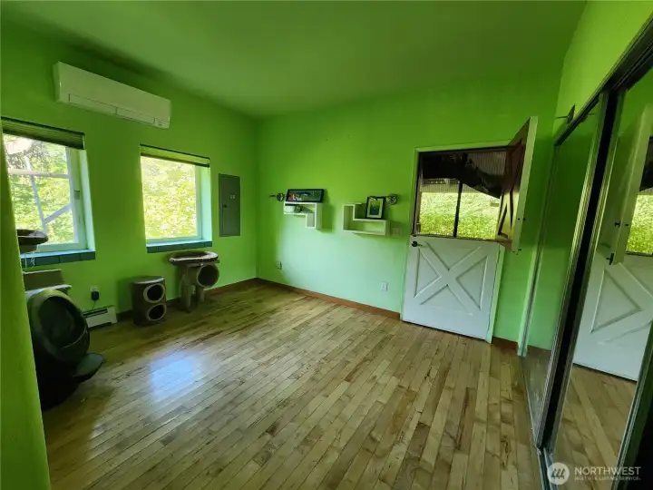 Main Home bedroom with Dutch door to covered, screened porch