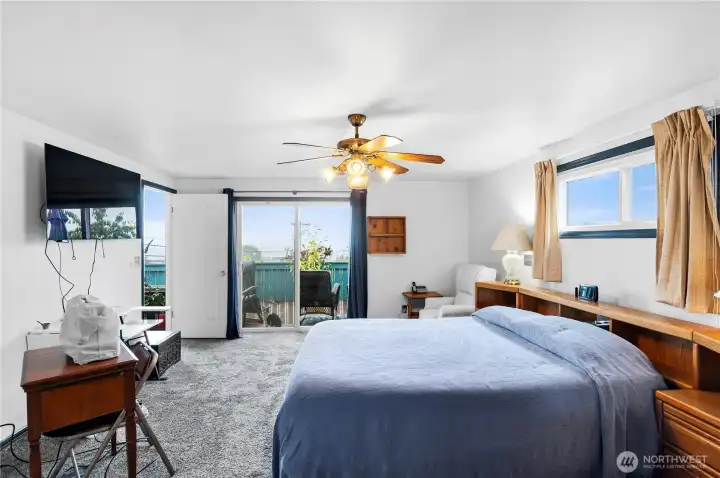 Primary suite has a view and sliding doors to the deck