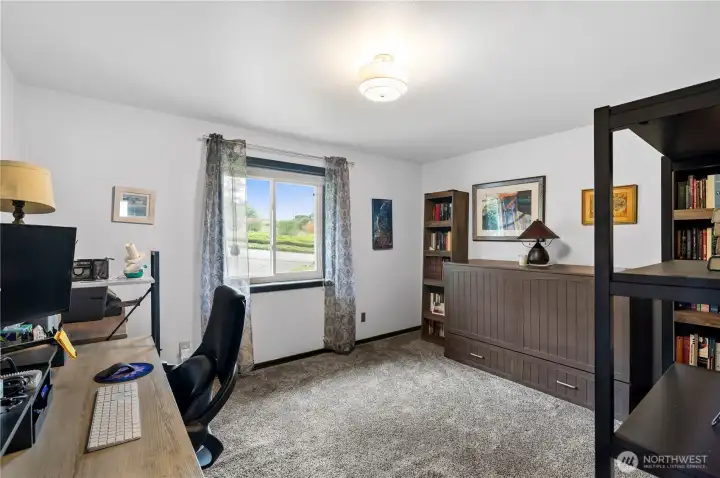 Upstairs bedroom #3 is being used as an office. Murphy bed on wall