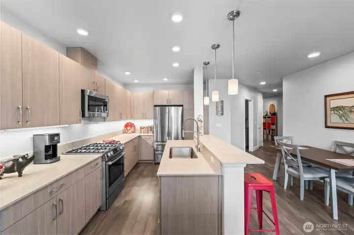 It is easy to entertain in the Quartz and stainless kitchen. Lots of counter space to put out your buffet and extra seating at the built-in breakfast bar.