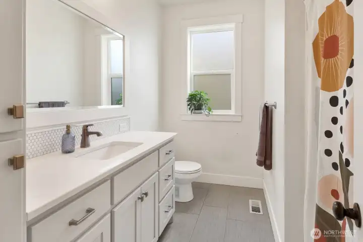 A centrally located guest bathroom offers convenience and style for family and visitors alike.