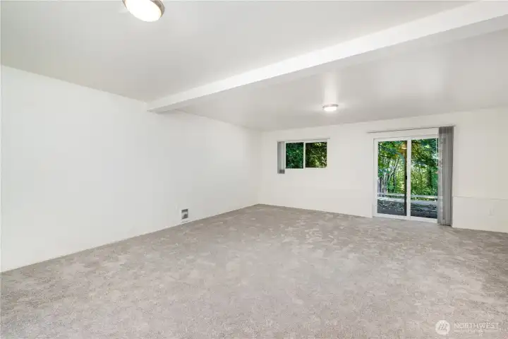 Large downstairs bedroom offers versatility with direct access to the backyard space.