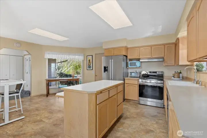 Main floor ~ kitchen w/ SS appliances, brand new gas stove & hood vent.