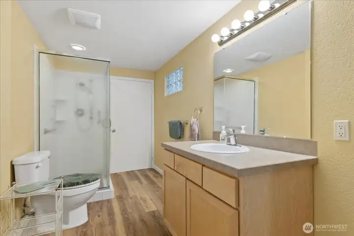 Downstairs 3/4 bath w/ a door off of the bedroom & front hallway for guests.