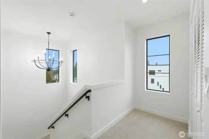 Stairway to upper level with plenty of natural light