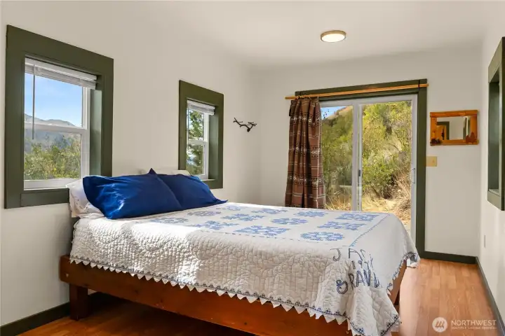 A spacious bedroom has been added onto the cabin for more living space.