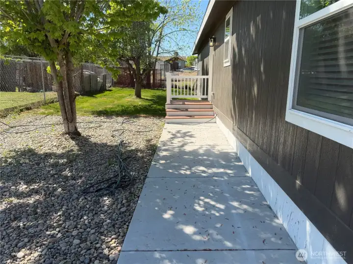 Side of home with trees for shade.