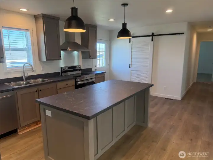 Another view of the kitchen. NOTE: Picture is of a different home w/same floor plan so colors may be different.