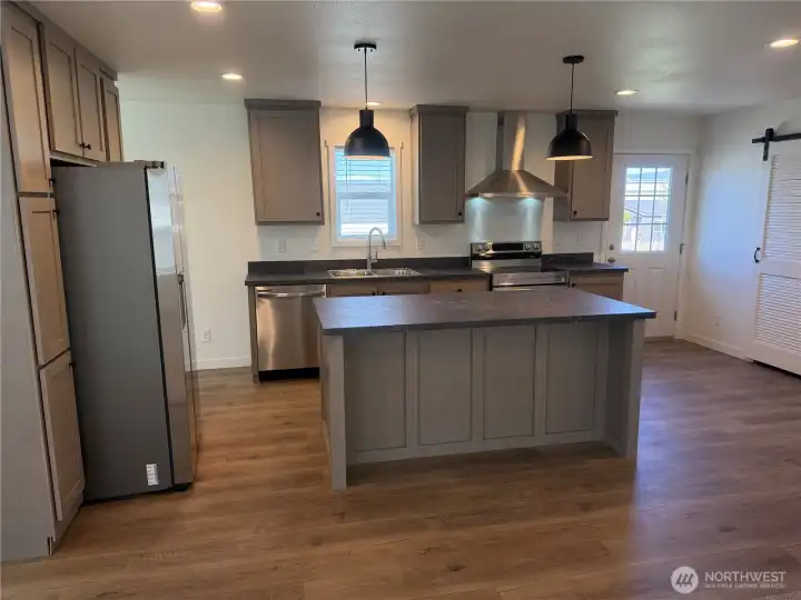 Kitchen w/SS appliances and a pantry. NOTE: Picture is of a different home w/same floor plan so colors may be different.