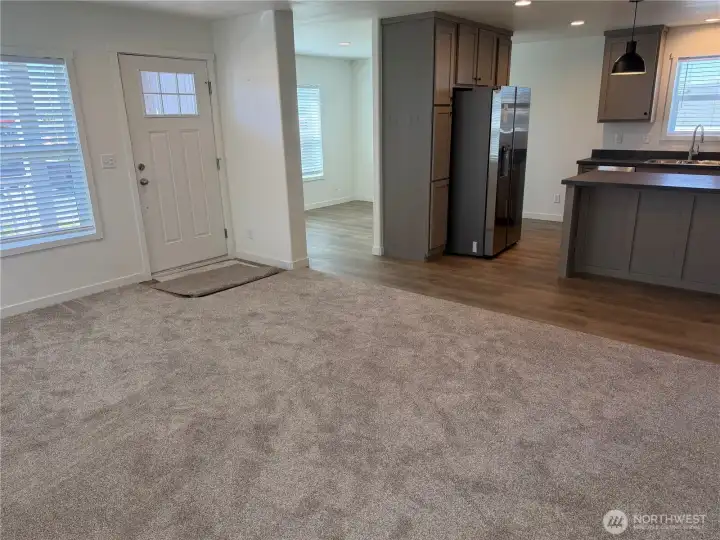 Living room looking into the kitchen and dining/flex room. NOTE: Picture is of a different home w/same floor plan so colors may be different.