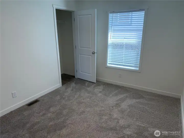 Bedroom 3 closet area. NOTE: Picture is of a different home w/same floor plan so colors may be different.