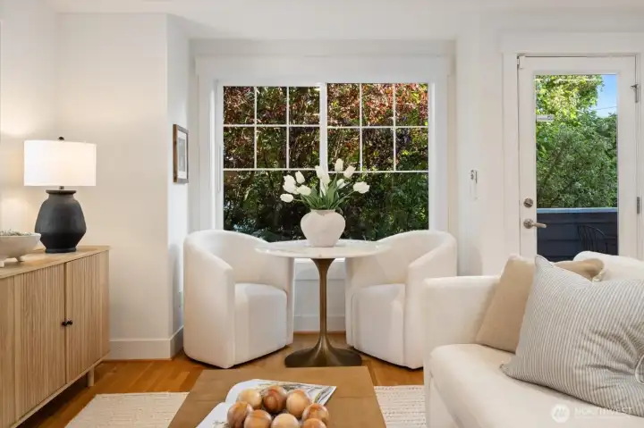 A sun drenched dining nook with treetop outlooks creates a tranquil setting for daily dining.