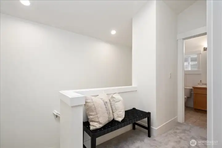 Vaulted ceilings enhance the sense of openness throughout the thoughtfully designed upper level.
