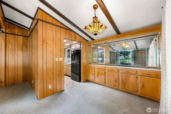 Dining area with built-in shelving and cabinets for extra storage. Dining area with built-in shelving and cabinets for extra storage.