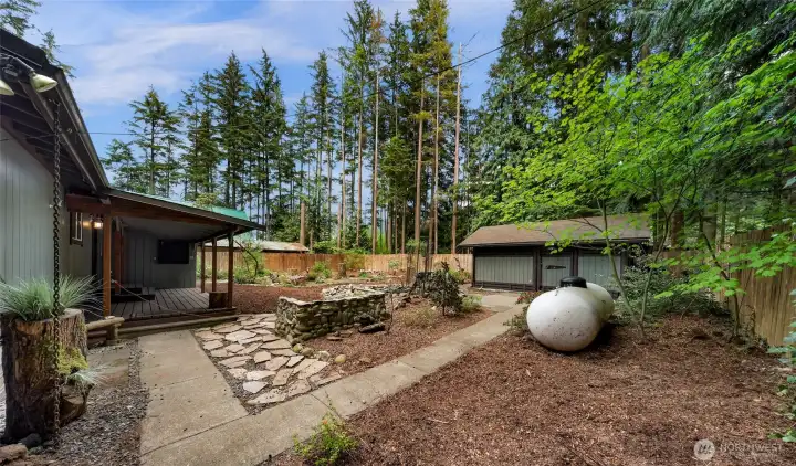 Rock surround built for BBQ and a covered back deck is nice for being outside in any weather. Rock surround built for BBQ and a covered back deck is nice for being outside in any weather.