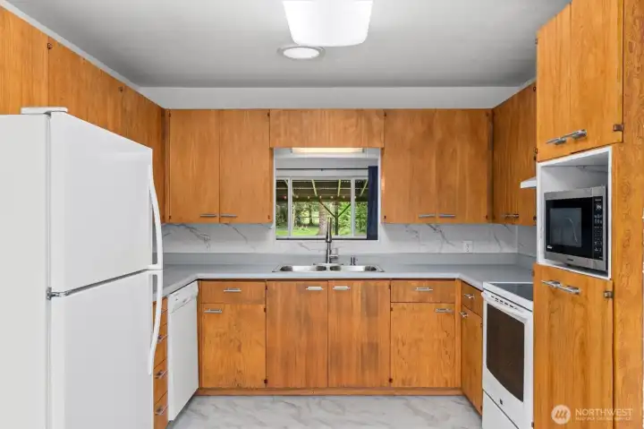 Enjoy a view into the  backyard while you're washing dishes.