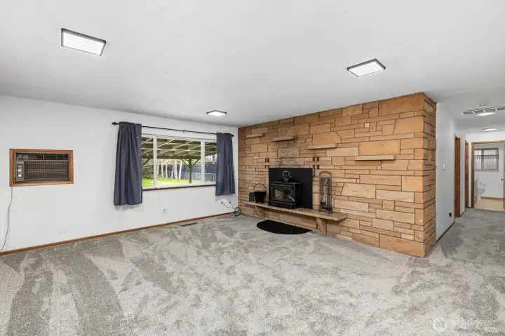 Living room with wood burning fireplace.