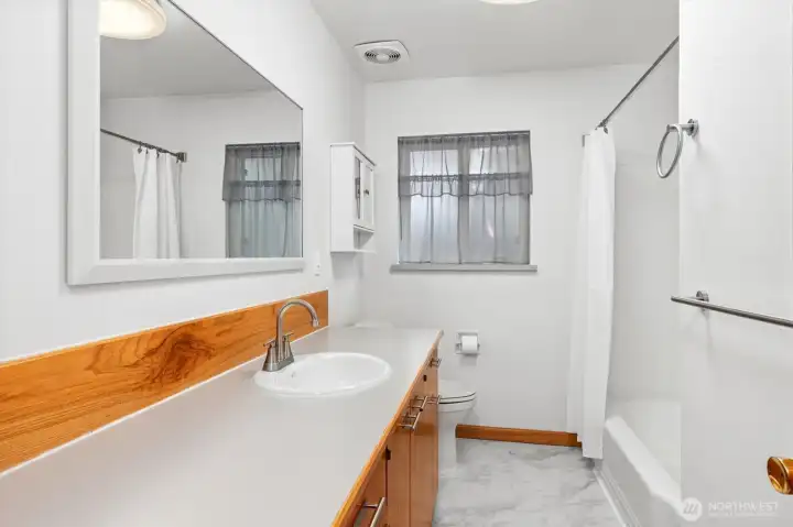 Full bath with oversized cabinets/countertops, all new fixtures and flooring.