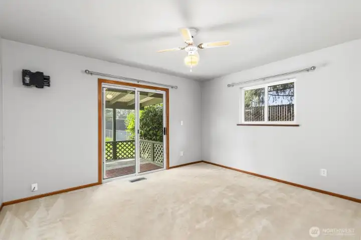 Primary bedroom with private back deck area.