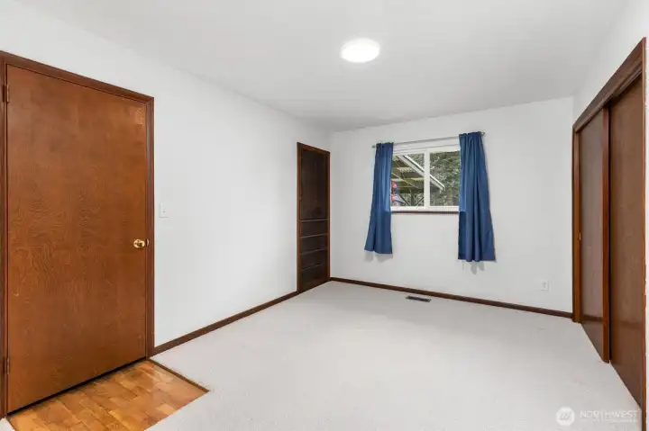 Bedroom #4 with built in storage. Access to the recently updated furnace is behind the door on the left.