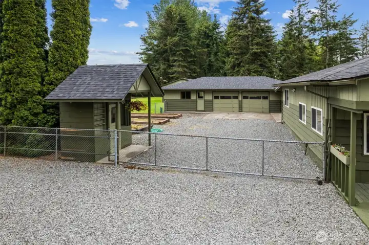 Fully fenced yard with plenty of parking. The oil tank is housed in the small building on the left with easy access for refills by Puget Sound Petroleum.
