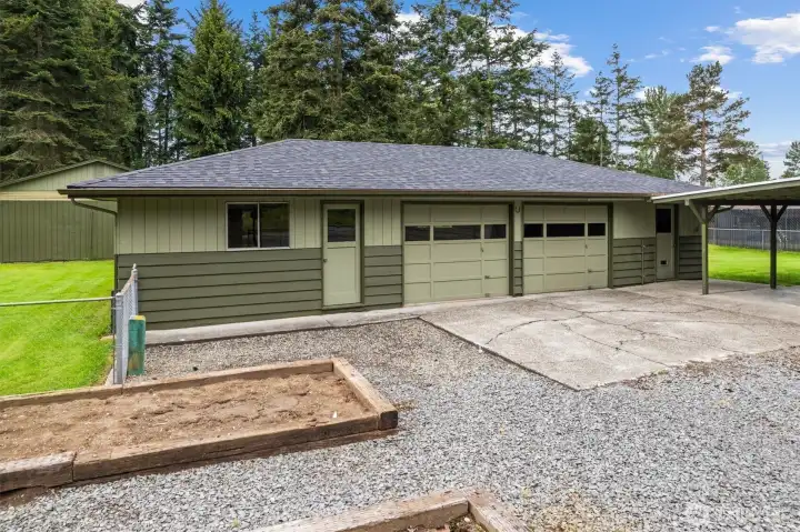 Two car garage with lots of additional workshop space.