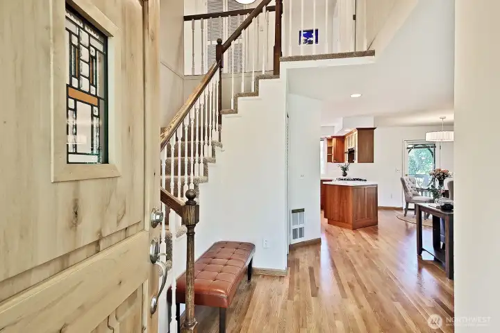 Hardwood floors and vaulted ceiling entry welcome you. Stairs to the left lead to the Primary Suite, 3 additional bedrooms, an office & a flex room. There is also a small bedroom and 3/4 bath on this main level.