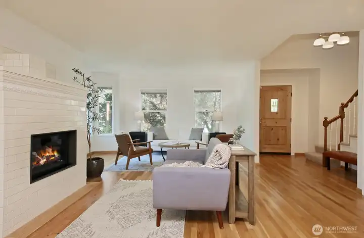 Generous living room with plenty of windows. Your back is to the kitchen. Both windows (straight ahead) have been replaced.