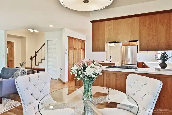 Looking back from the dining area. There is closet/pantry space in the closet (louvered white doors) under the stairs along with a whole wall of pantry space on the wall to the right of the louvered door closet.