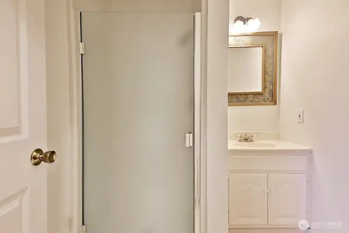 3/4 Main Level Bathroom located off the kitchen near the entrance to the garage and across from the laundry room.