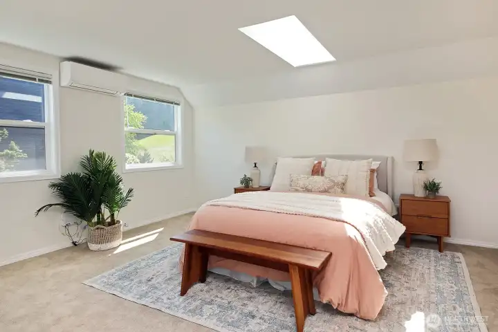 Spacious Primary Suite with two standard sized closets, skylights and mini-split. This room is above the garage and is located on the south side of the home.