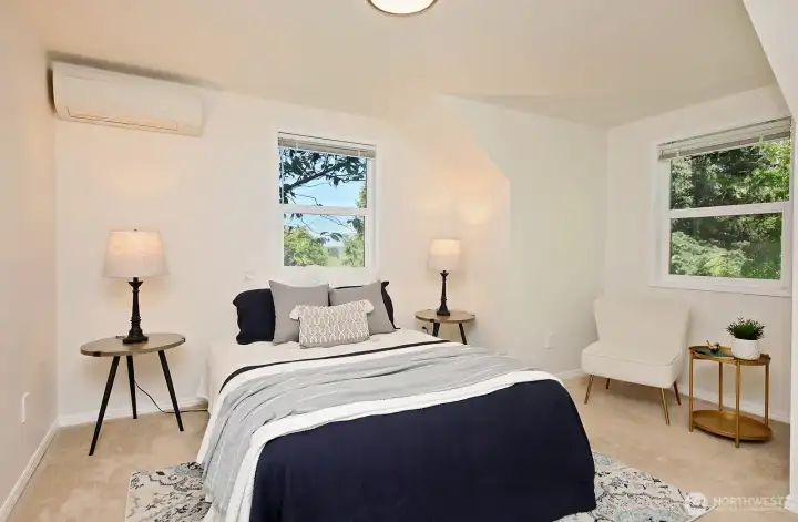 This is the bedroom that is at the top of the stairwell and in the northwest corner of your home (Bedroom #3). The window straight ahead is the one with your peek-a-boo views of the Sound and Cascades. Mini-split in this room and ...another cozy space here too!