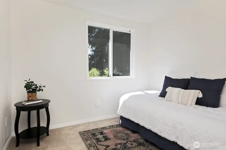 This is bedroom #5 which is located adjacent to the Primary Suite and has a standard sized closet. It looks out upon the western side (back yard) of the home.