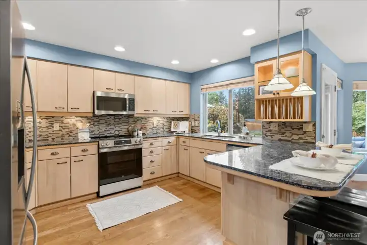Functional kitchen with abundant storage and views of the backyard.