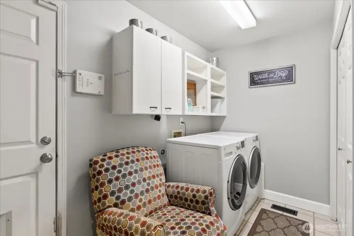 Dedicated laundry room with extra storage.