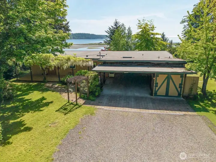 The 1966 home has a 6-year-old Built Up Roof which is extremely waterproof and long-lasting. A two-car carport and a small shop on the right.