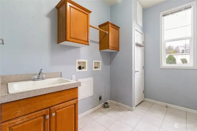 Laundry room with sink and additional storage